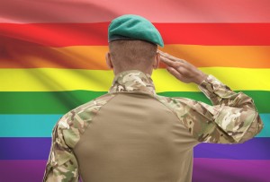 Dark-skinned soldier with flag on background - LGBT people