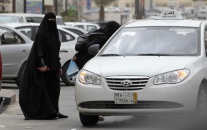 Saudi Arabian women, who are banned from driving, board a tax. Photo courtesy of WBUR public radio.