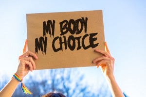 A woman holds a sign at a reproductive rights protest. Getty Images.